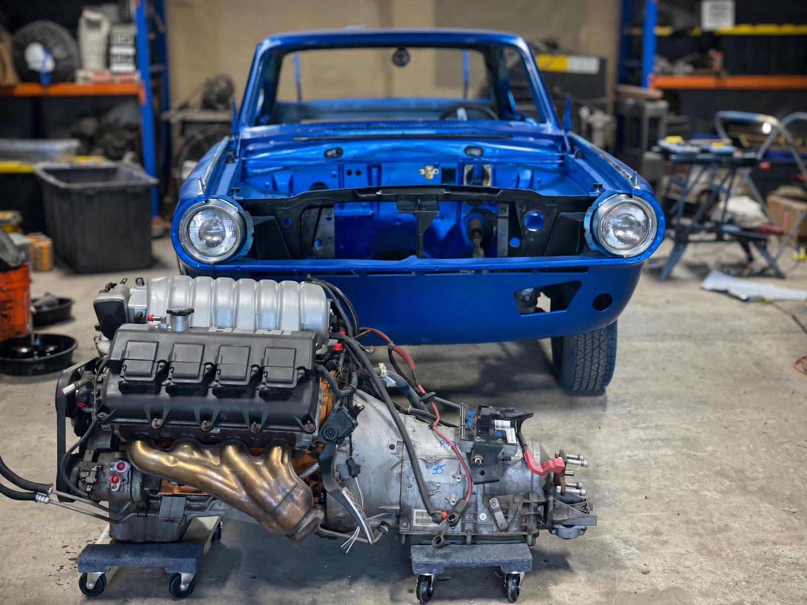 Blue 1965 Dodge Dart with a HEMI engine and transmission ready for installation